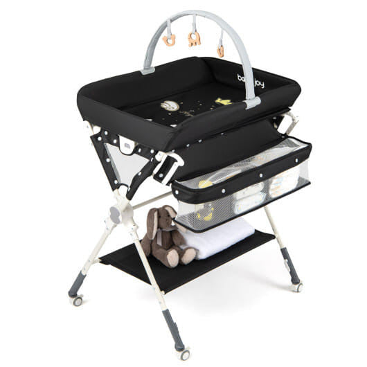 Black foldable baby changing table station with storage bag, bottom shelf, and wheels. — view 2