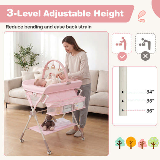 Black foldable baby changing table station with storage bag, bottom shelf, and wheels. — view 9