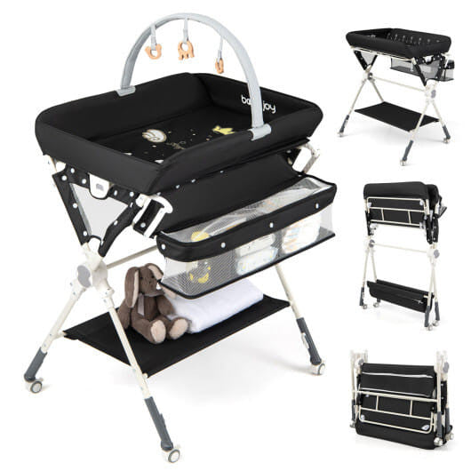 Black foldable baby changing table station with storage bag, bottom shelf, and wheels. — view 10