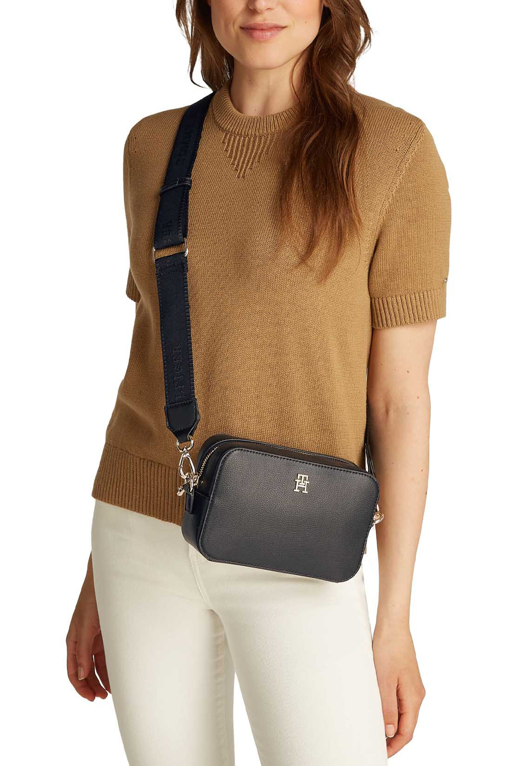 Women's black faux-leather crossbody shoulder bag with adjustable logo strap and front monogram plaque — view 4