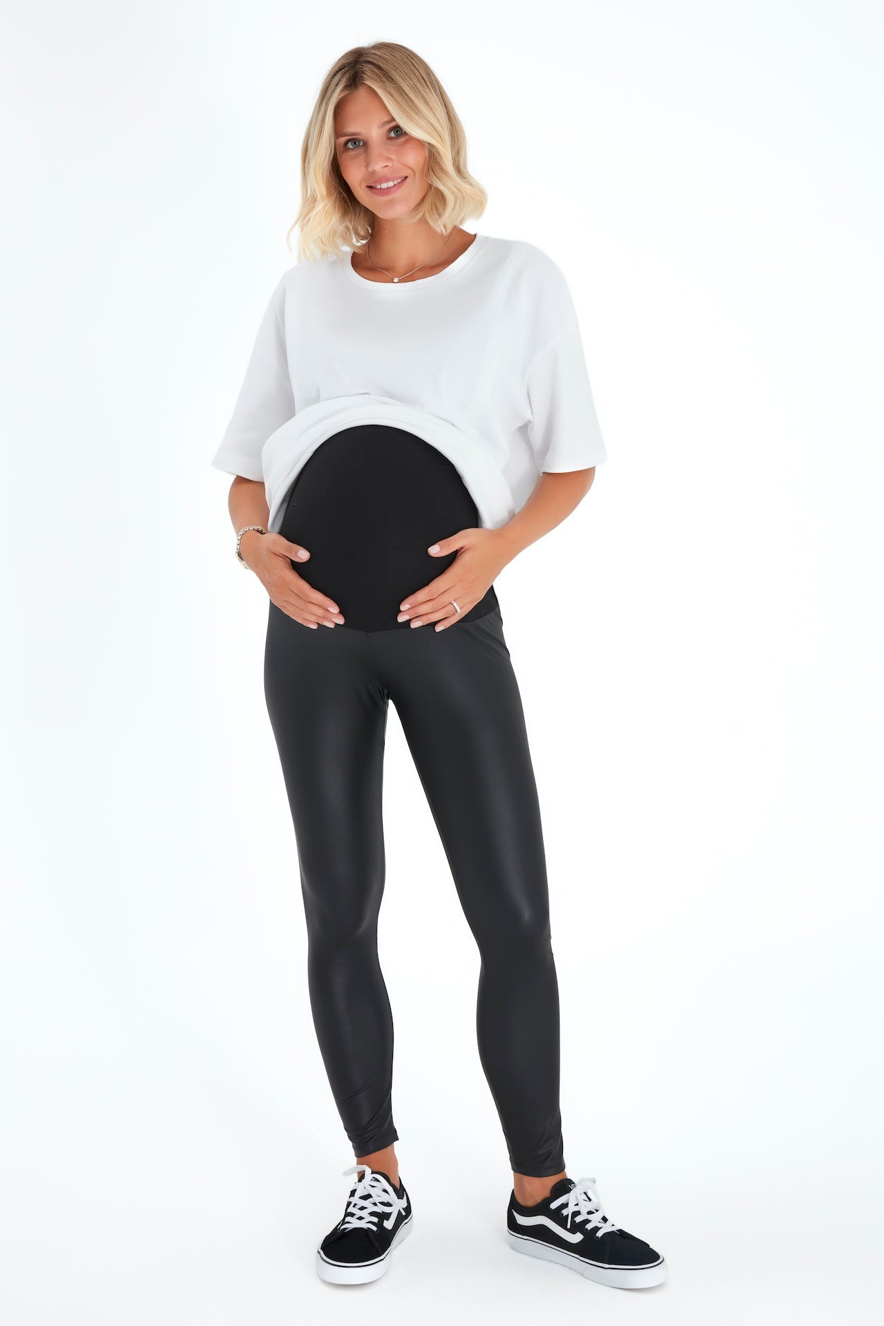 Black faux leather maternity leggings featuring a comfortable foldover cotton waistband — view 2