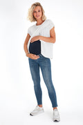 Skinny foldover waistband maternity jeans featuring a stretchy over-the-bump fit for pregnancy comfort