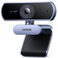 Black 1080P HD USB webcam with dual microphones clipped onto a computer monitor.