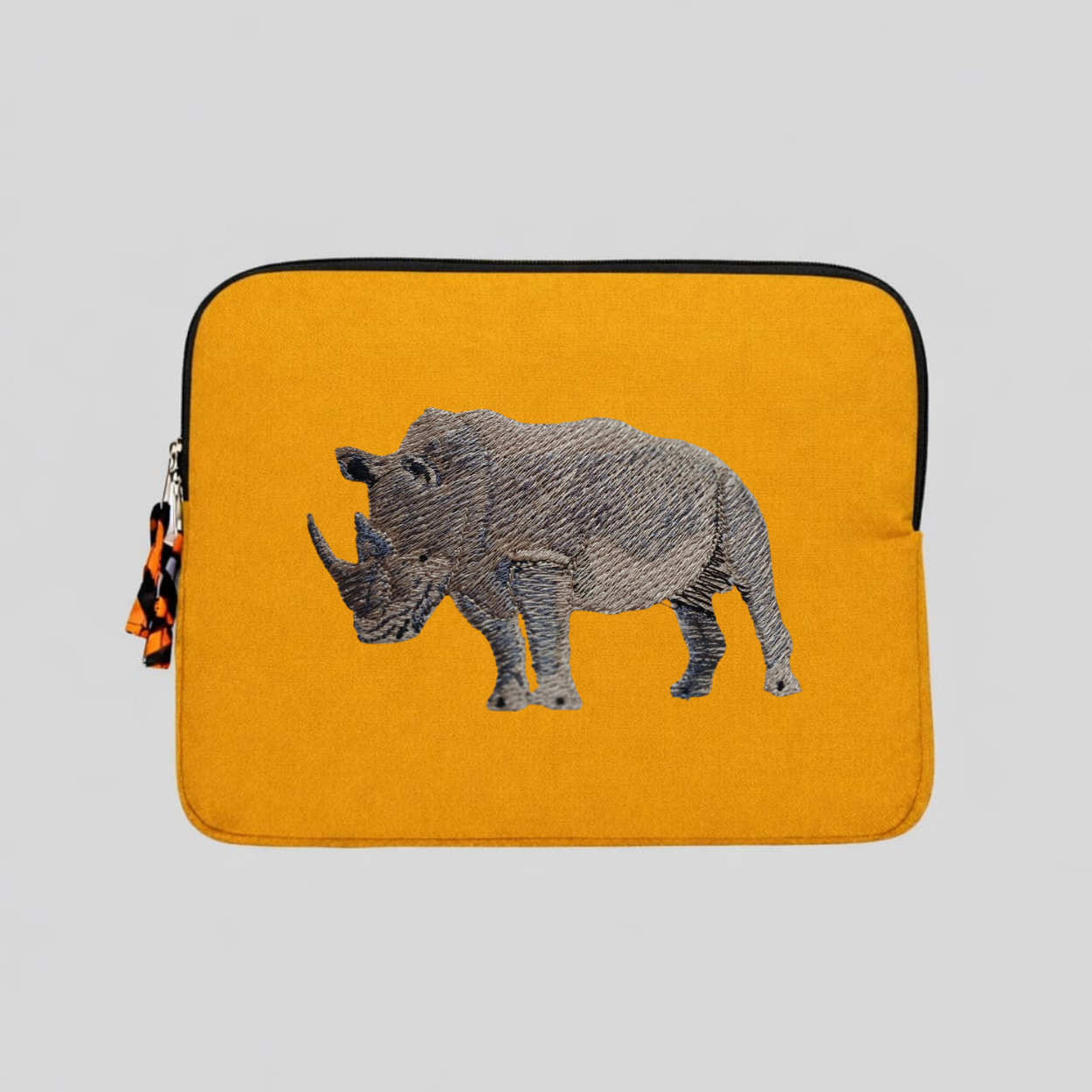 Rhino laptop sleeve made of Kenyan cotton canvas with animal embroidery in warm earthy colors — view 3