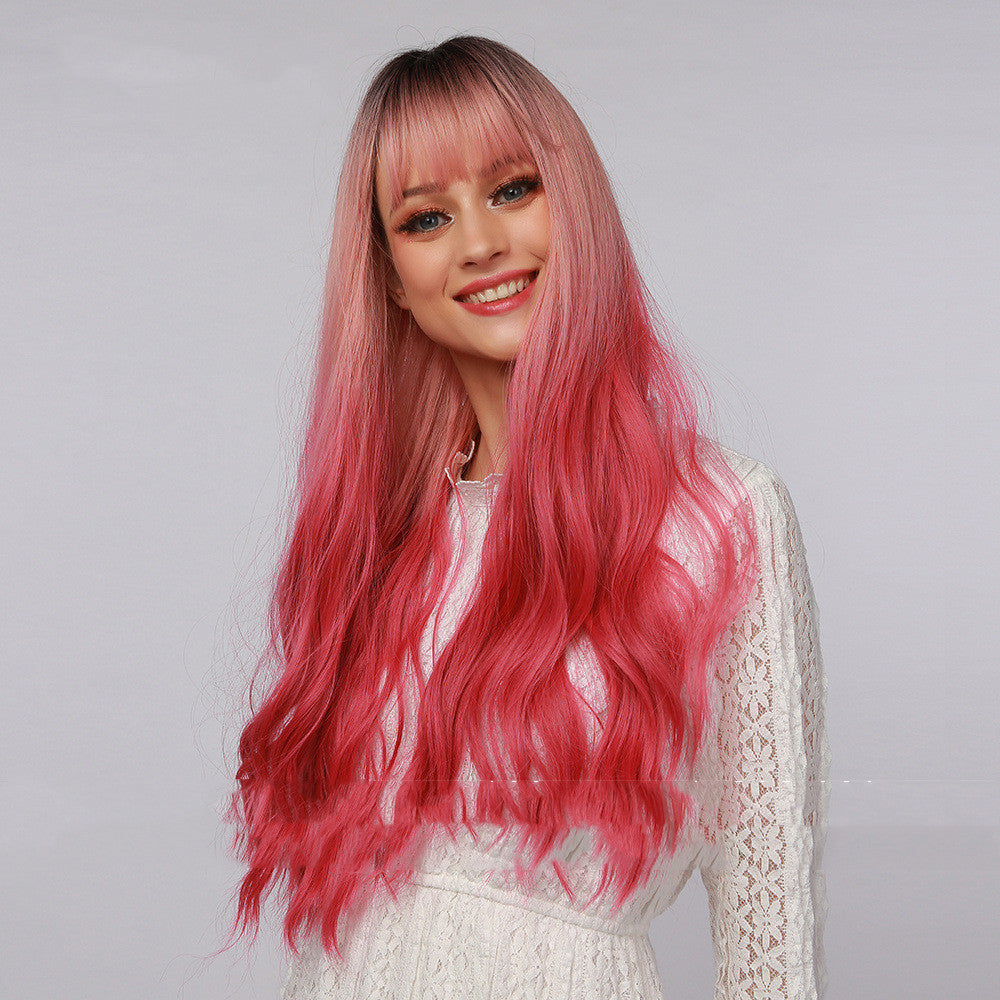 Long curly synthetic wig with straight bangs in black to strawberry pink ombre gradient — view 4