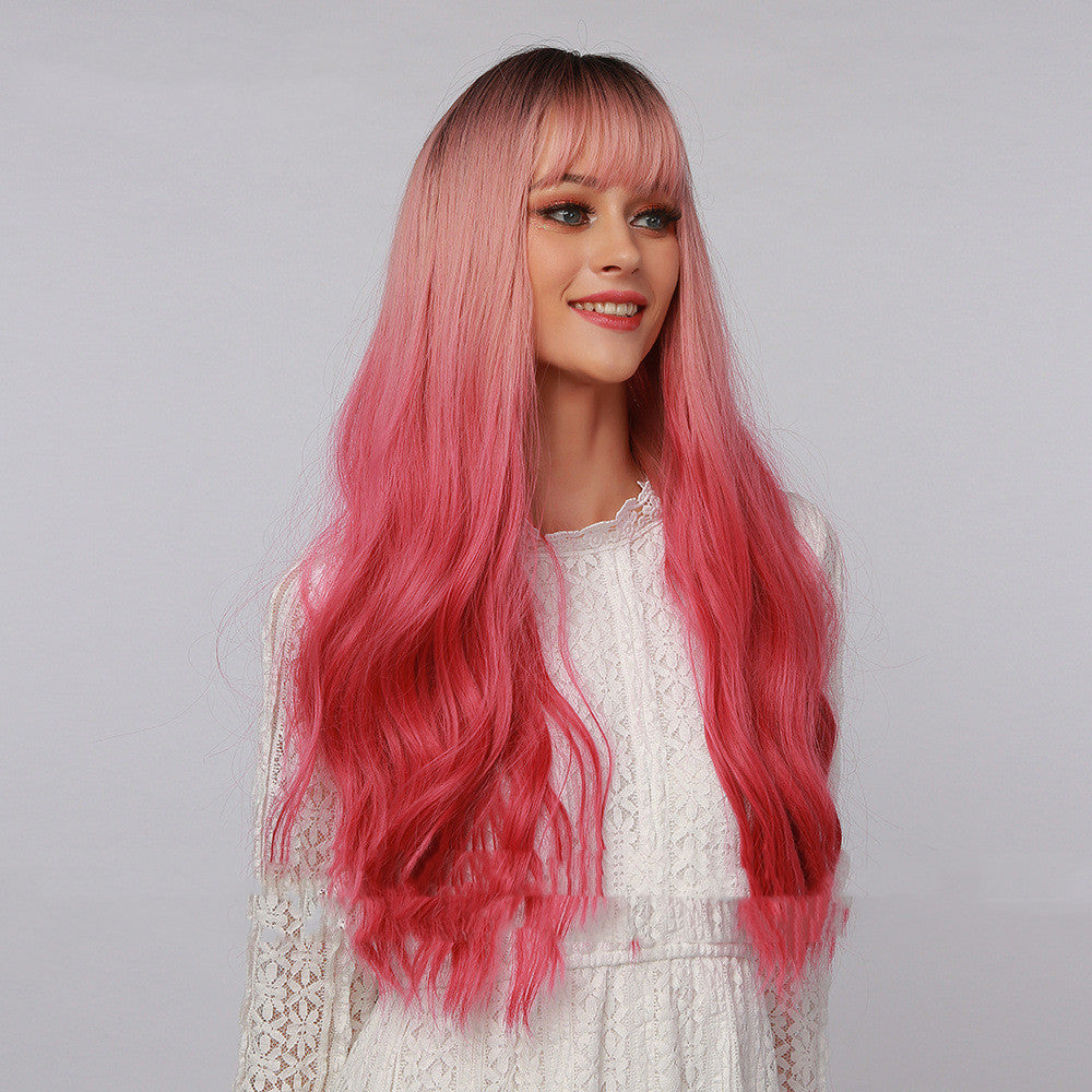 Long curly synthetic wig with straight bangs in black to strawberry pink ombre gradient — view 5