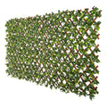 Expandable artificial jasmine trellis privacy screen featuring lifelike green foliage on a diamond lattice.