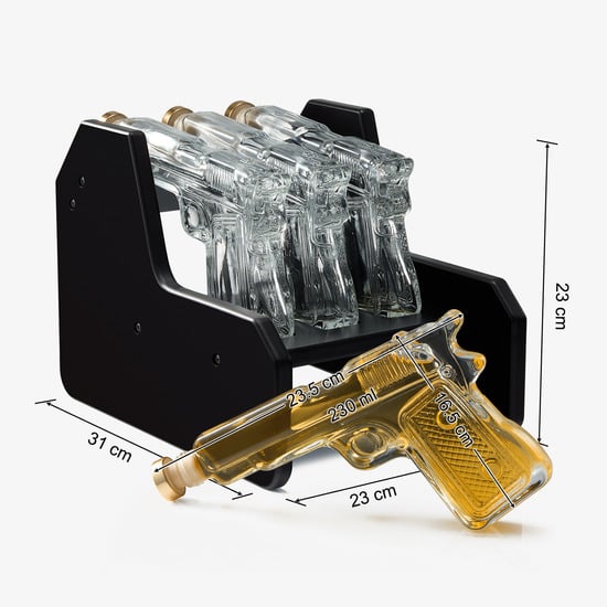 3-pistol whiskey decanter set made of glass resting on a rich mahogany wood display base — view 4