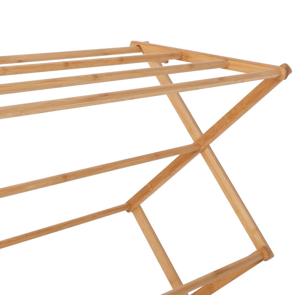 Natural bamboo foldable clothes drying rack with eleven hanging bars on a white background. — view 4