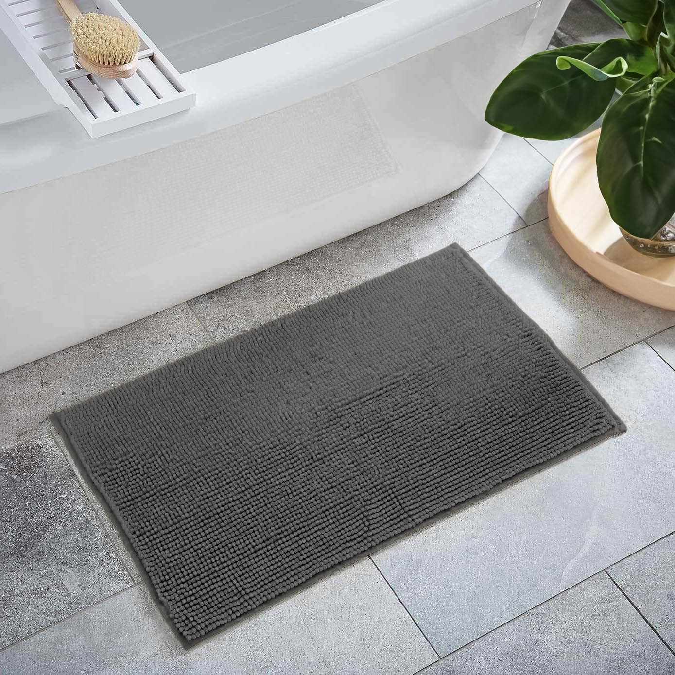 Dark gray plush washable bath mat made of soft polyester shag for modern bathroom floors