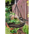 Black iron mesh bird feeder and seed tray hanging from a chain in an outdoor garden