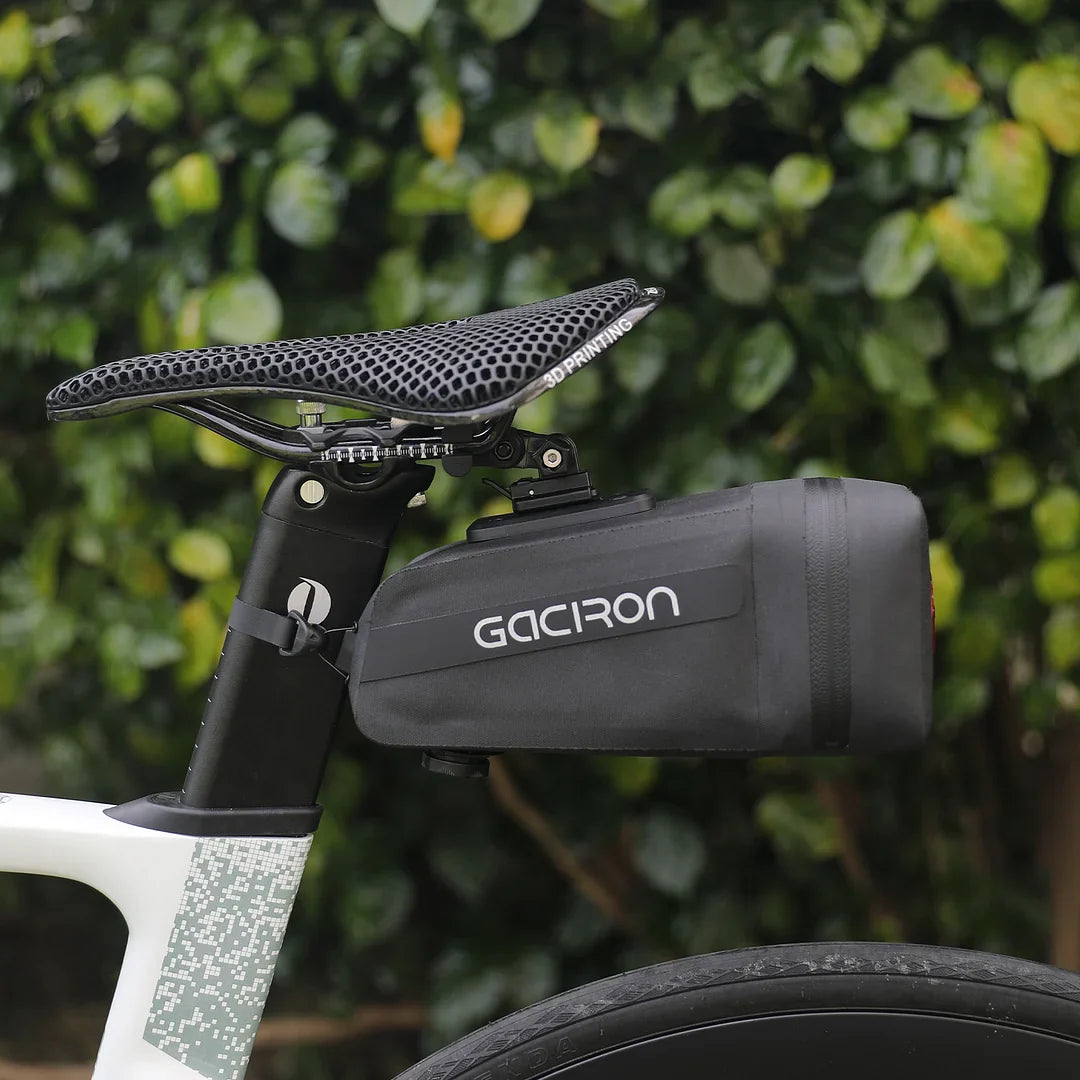 Black waterproof bicycle saddle bag with integrated smart taillight mounted securely under a bike seat — view 5