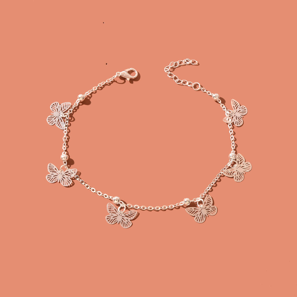 Silver-tone butterfly charm anklet chain displayed as delicate boho beach foot jewellery. — view 2