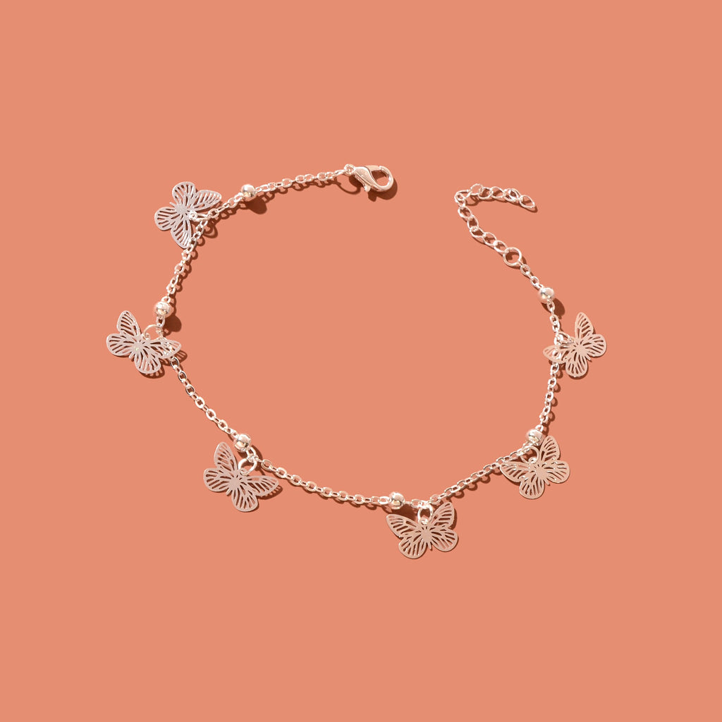 Silver-tone butterfly charm anklet chain displayed as delicate boho beach foot jewellery. — view 3