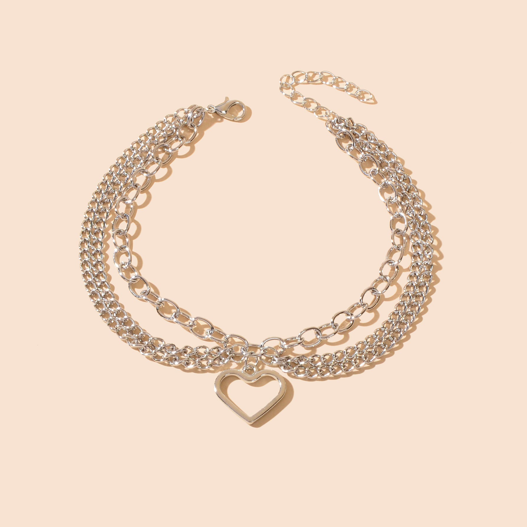 Multi-layer silver chain beach anklet featuring a delicate dangling tassel and a decorative heart charm — view 2