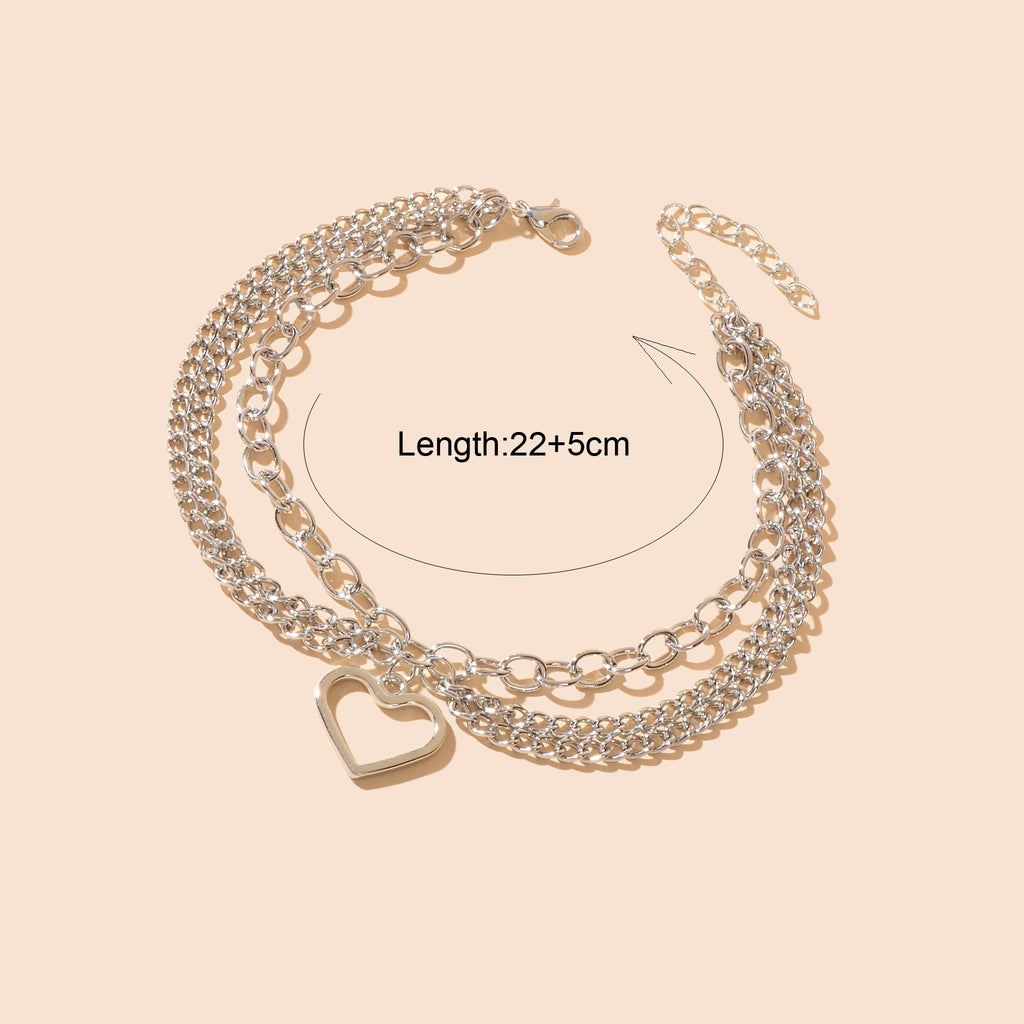 Multi-layer silver chain beach anklet featuring a delicate dangling tassel and a decorative heart charm — view 4