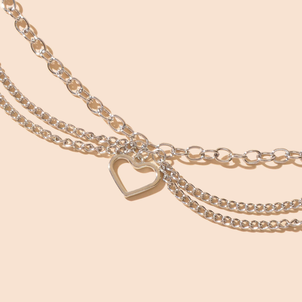 Multi-layer silver chain beach anklet featuring a delicate dangling tassel and a decorative heart charm — view 5