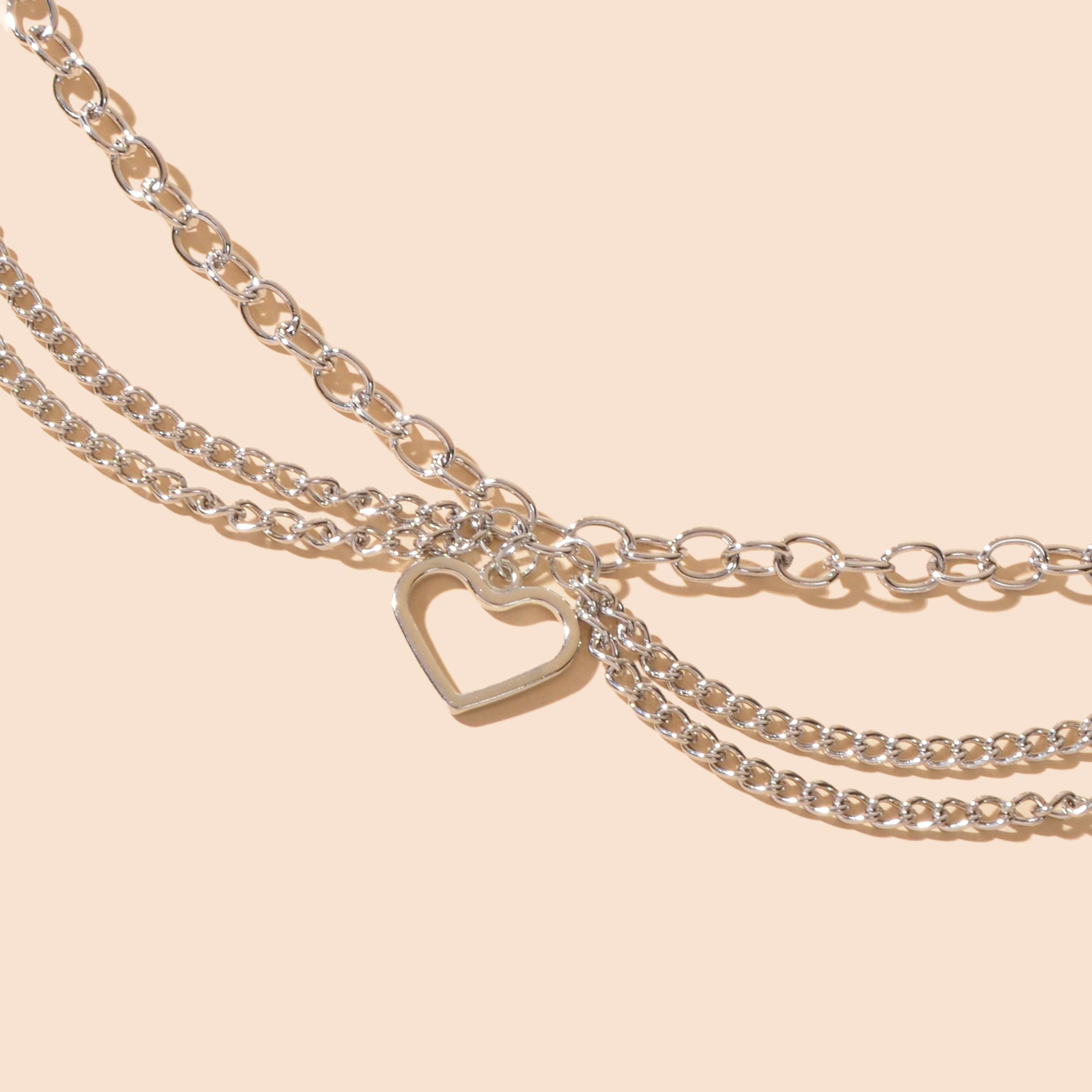 Multi-layer silver chain beach anklet featuring a delicate dangling tassel and a decorative heart charm — view 5