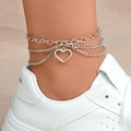 Multi-layer silver chain beach anklet featuring a delicate dangling tassel and a decorative heart charm
