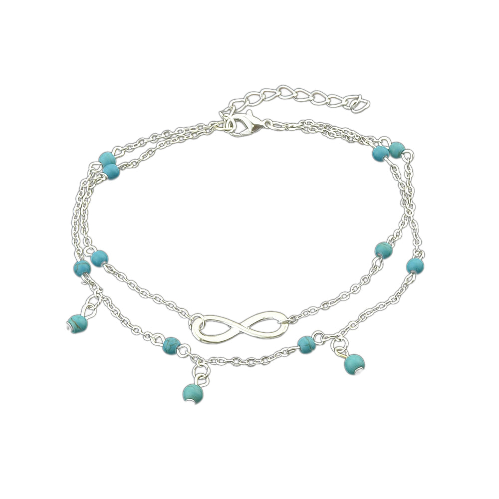 Turquoise infinity anklet with double layer silver chain worn on a bare foot. — view 5