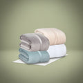 BSB collection plush fleece blanket with suede mink binding folded on a comfortable modern bed
