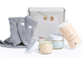 Organic new baby gift set in box with natural diaper balm, baby powder, and bib