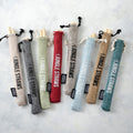 Set of six reusable bamboo drinking straws with a natural jute travel pouch and cleaning