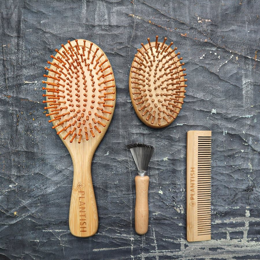 All-in-one bamboo hair brush set including paddle brush, travel brush, comb, and brush cleaner tool