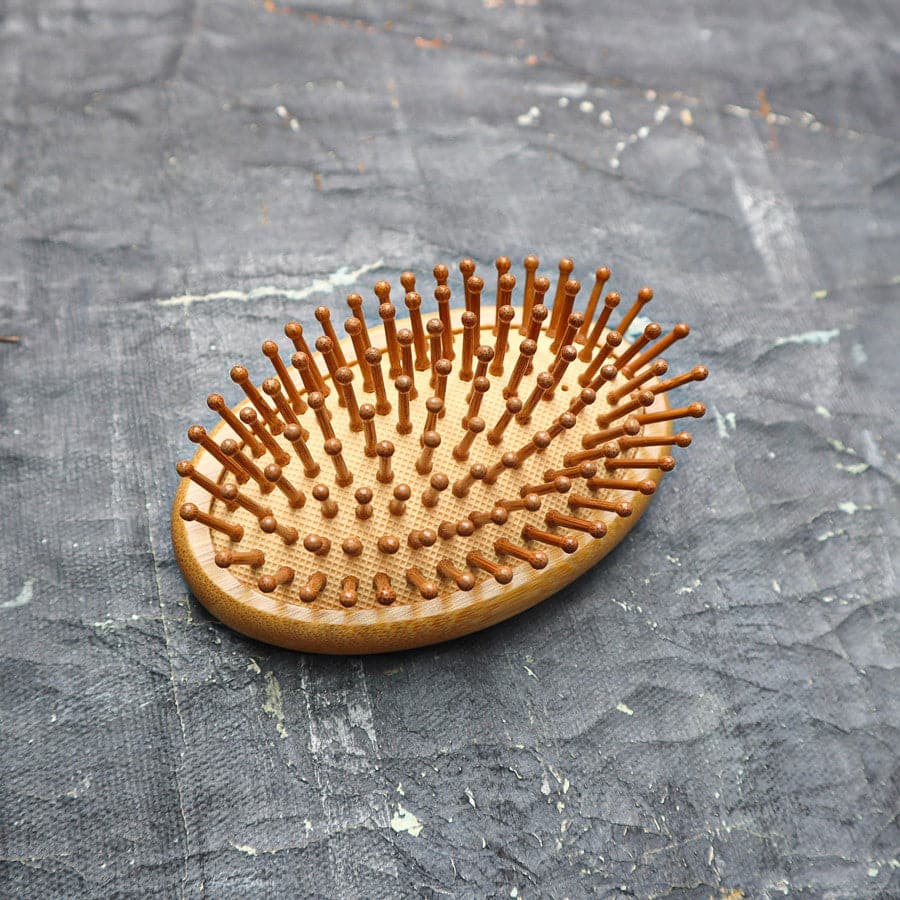 All-in-one bamboo hair brush set including paddle brush, travel brush, comb, and brush cleaner tool — view 3