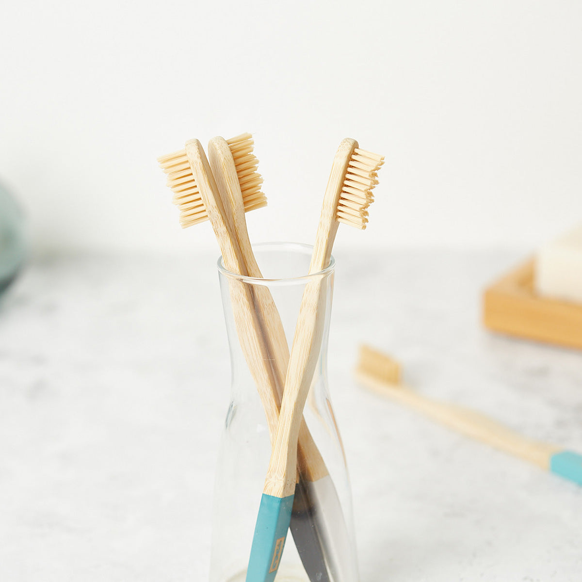 Set of four natural bamboo toothbrushes with soft bristles in zero waste kraft paper packaging — view 4