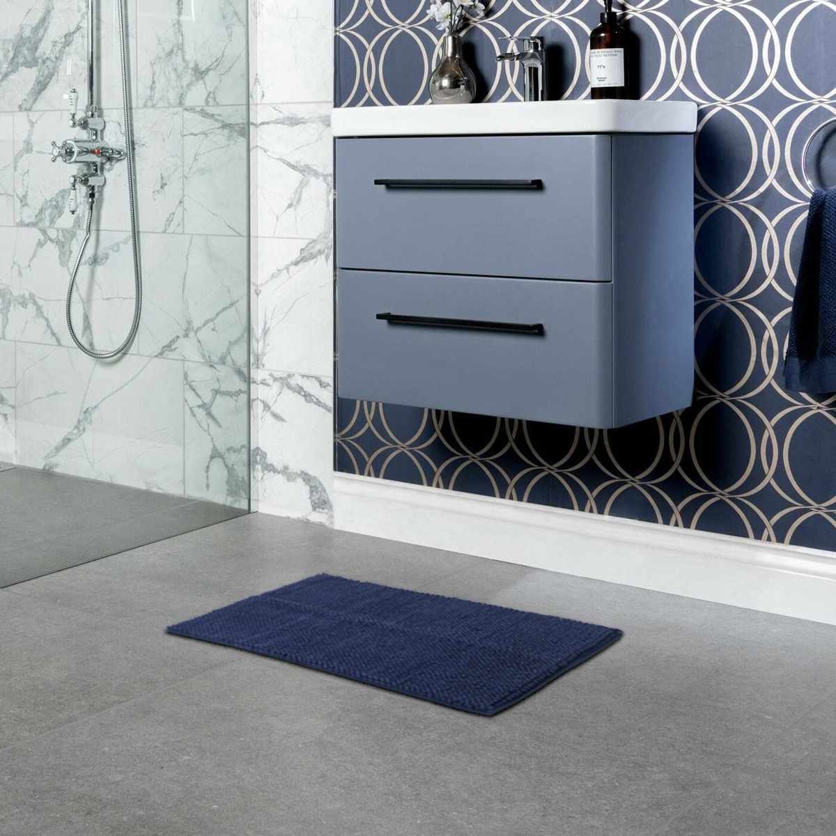 Plush navy blue washable bath mat with thick polyester shag texture on a bathroom floor — view 3