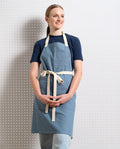 Eco-friendly cotton bib apron with deep front pockets and adjustable straps for chefs and bakers