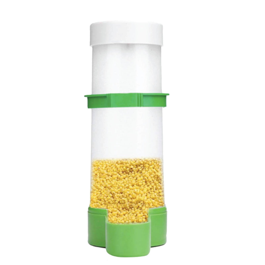 Green and clear plastic automatic bird food dispenser attached to wire cage bars — view 2
