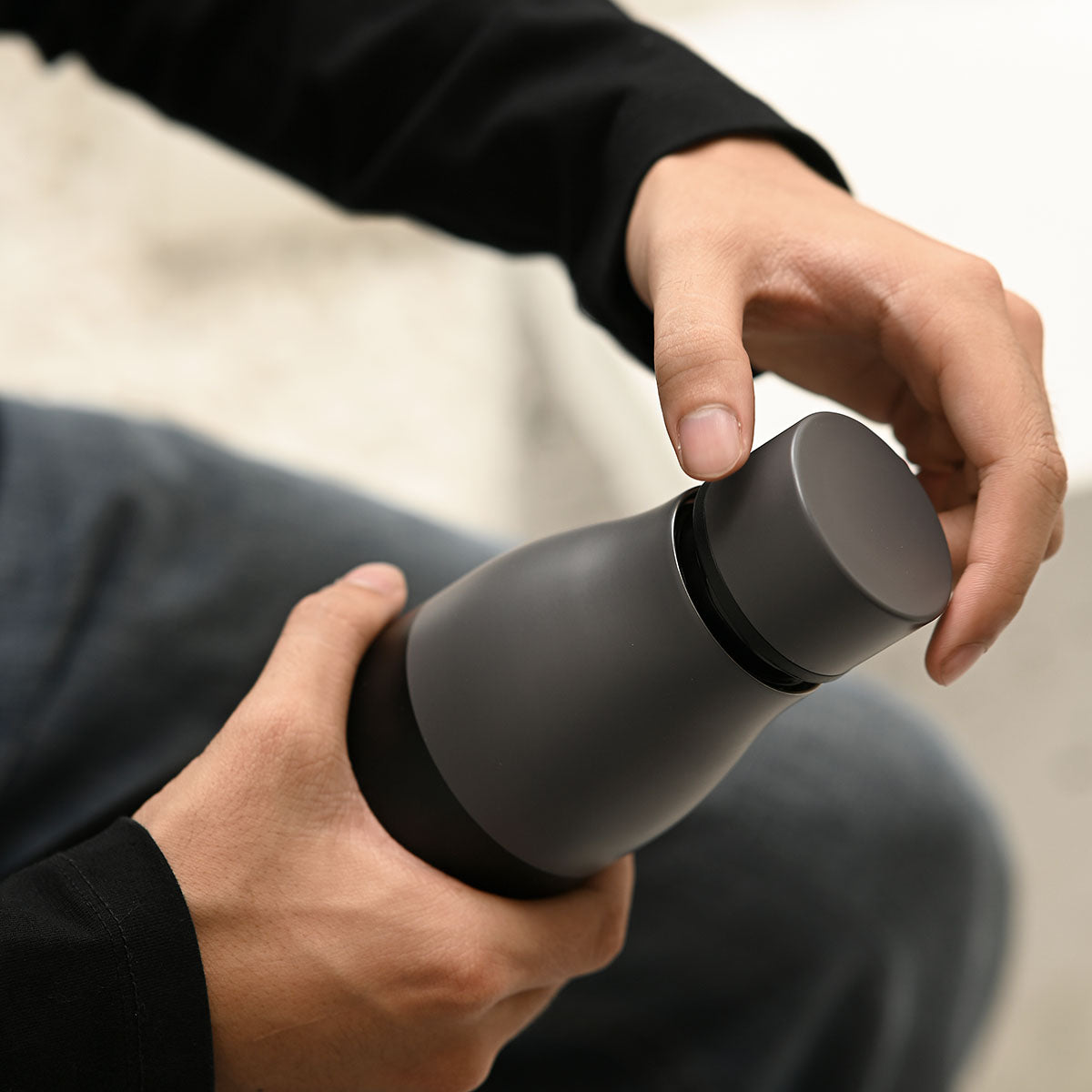 Reusable stainless steel water bottle in sleek matt black finish with an airtight screw lid — view 2