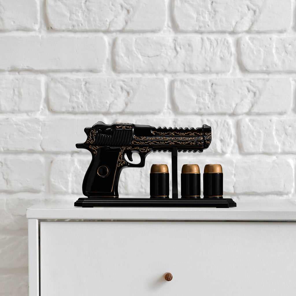 Black hand painted pistol whiskey decanter with three shot glasses on wooden display stand — view 5