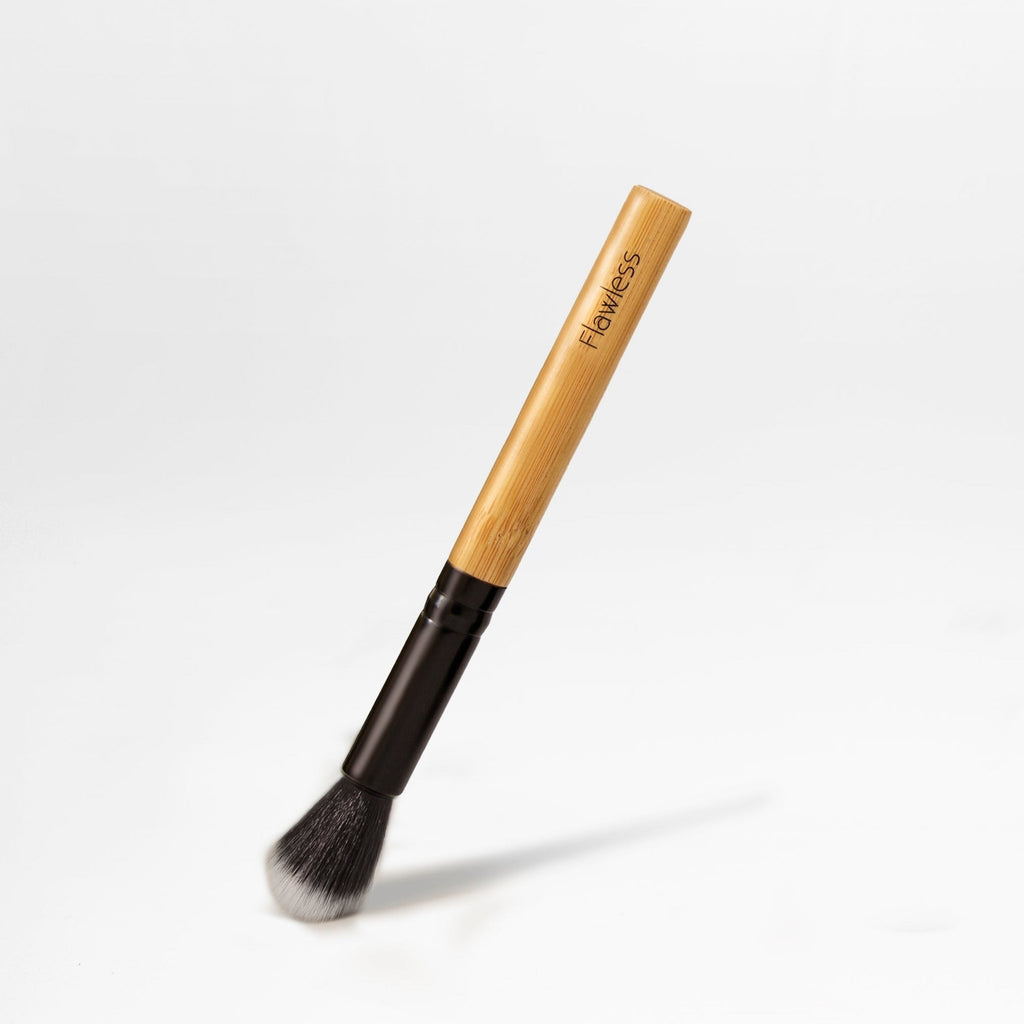 Vegan highlighter brush with natural bamboo handle and soft synthetic bristles for precision makeup