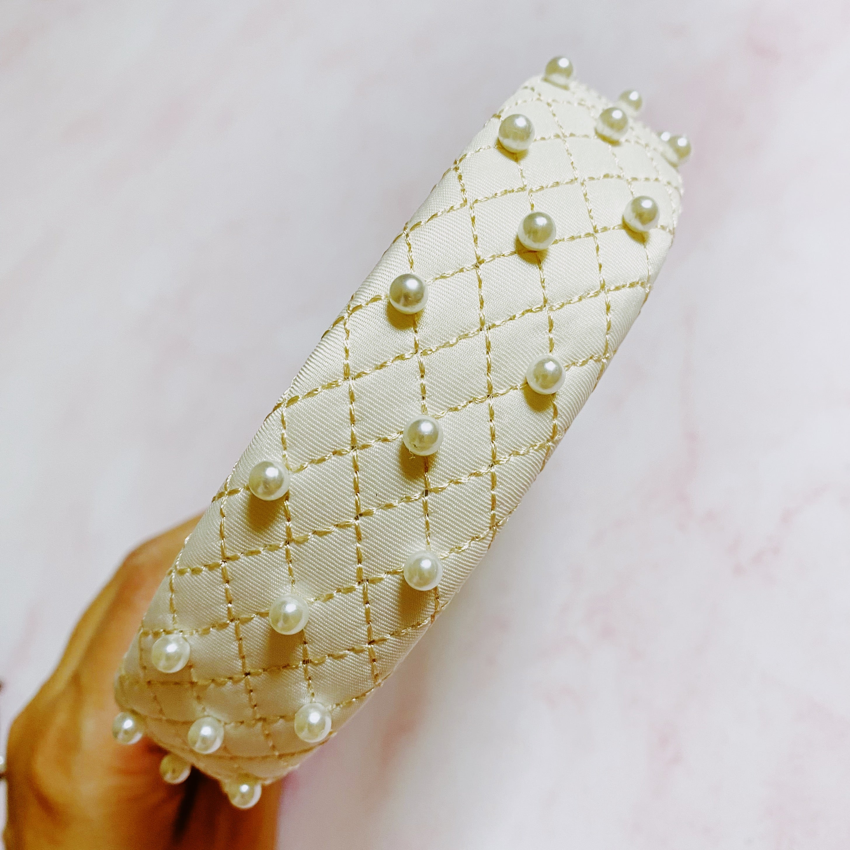 Quilted elegance pearl headband in soft fabric featuring hand-nailed pearls and smooth padded edges — view 3