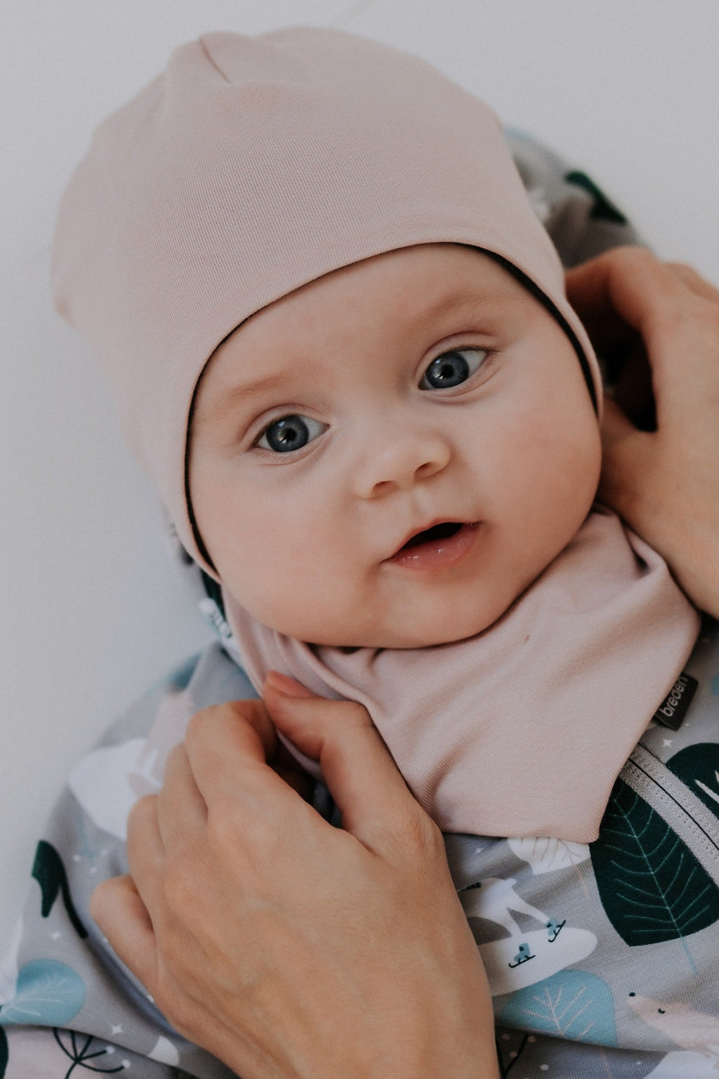 Winter merino baby hat in balaclava style covering the head, ears, and neck.