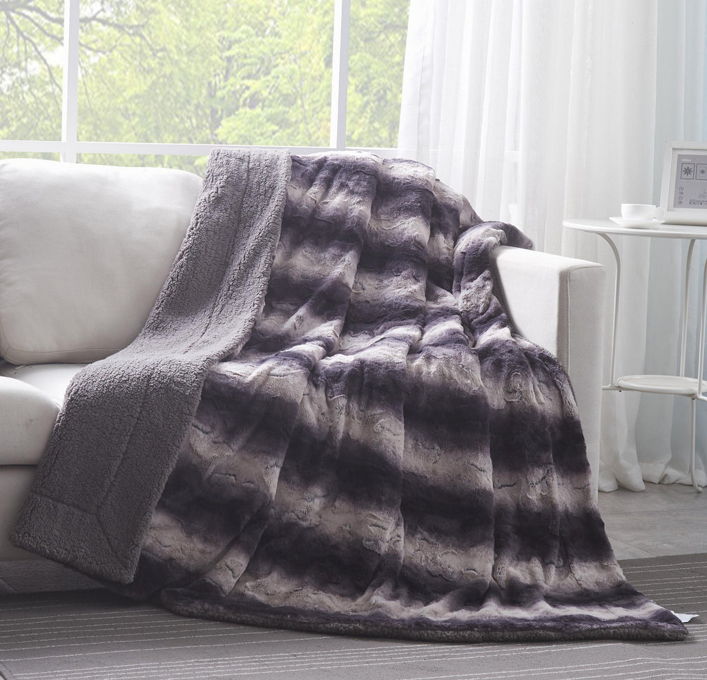 Luxury black striped faux fur throw blanket draped gracefully over a sofa with thick sherpa fleece