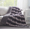 Luxury black striped faux fur throw blanket draped gracefully over a sofa with thick sherpa fleece