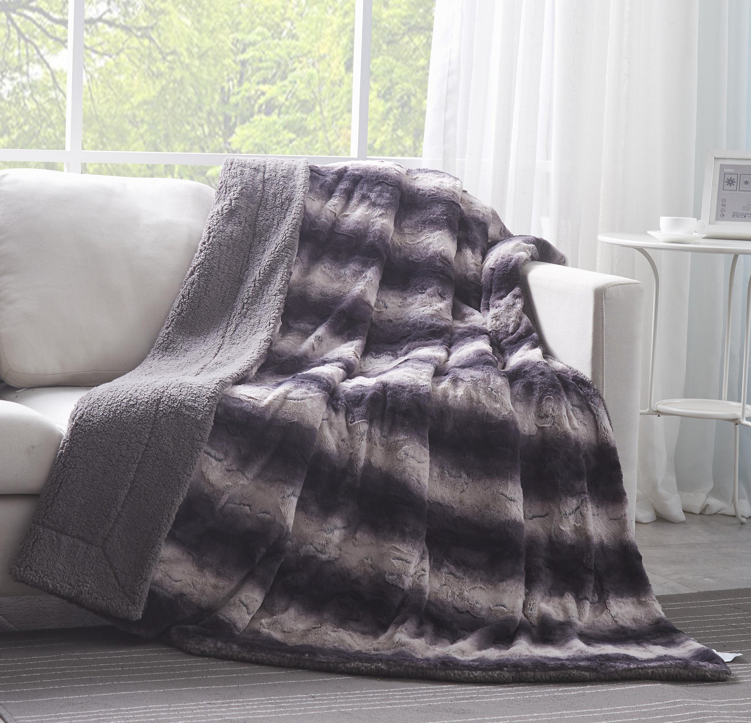 Luxury black striped faux fur throw blanket draped gracefully over a sofa with thick sherpa fleece
