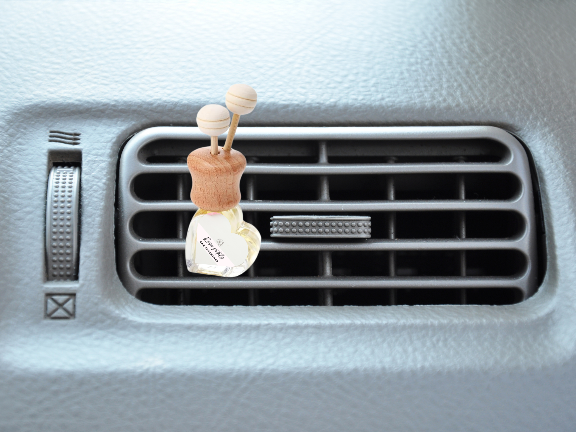 Floral vent car diffuser in sleek glass bottle with wooden reed sticks and sturdy mounting clip — view 4