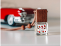 Fruity hanging car freshener in glass bottle with wooden cap and hanging rope, tropical scent.