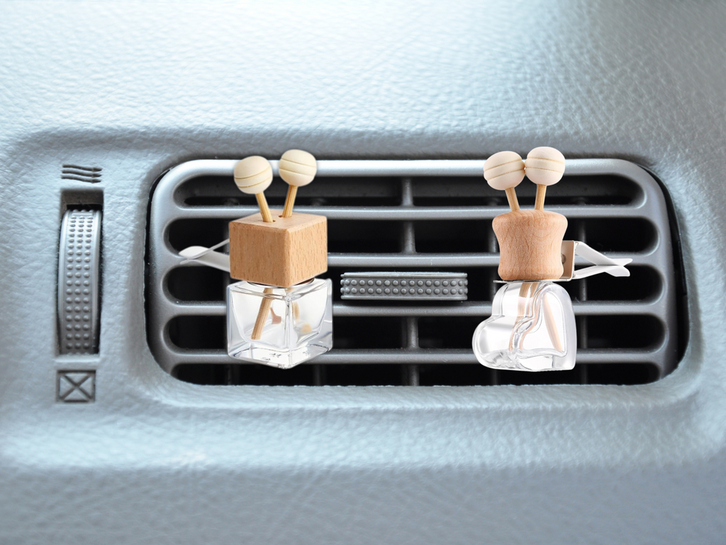 Floral vent car diffuser in sleek glass bottle with wooden reed sticks and sturdy mounting clip — view 5