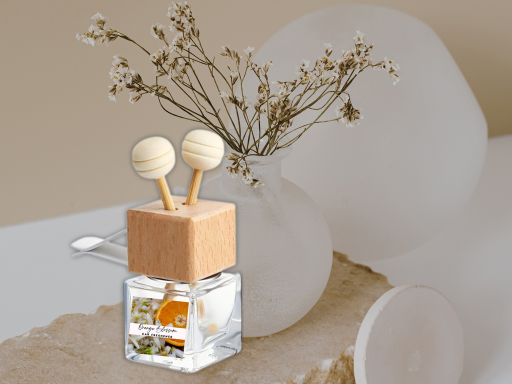 Floral vent car diffuser in sleek glass bottle with wooden reed sticks and sturdy mounting clip — view 2