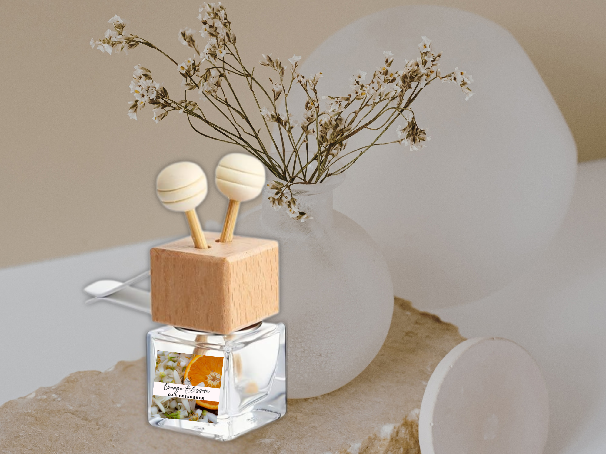Floral vent car diffuser in sleek glass bottle with wooden reed sticks and sturdy mounting clip — view 2