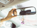 Glass hanging car freshener bottle with a wooden cap and hanging rope for aromatic commuting