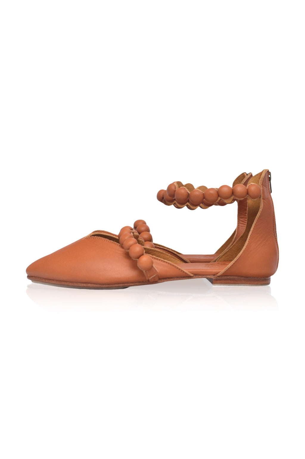 Tan leather ballet flats with pointy toe, wrapped buttons, and ankle strap details — view 3