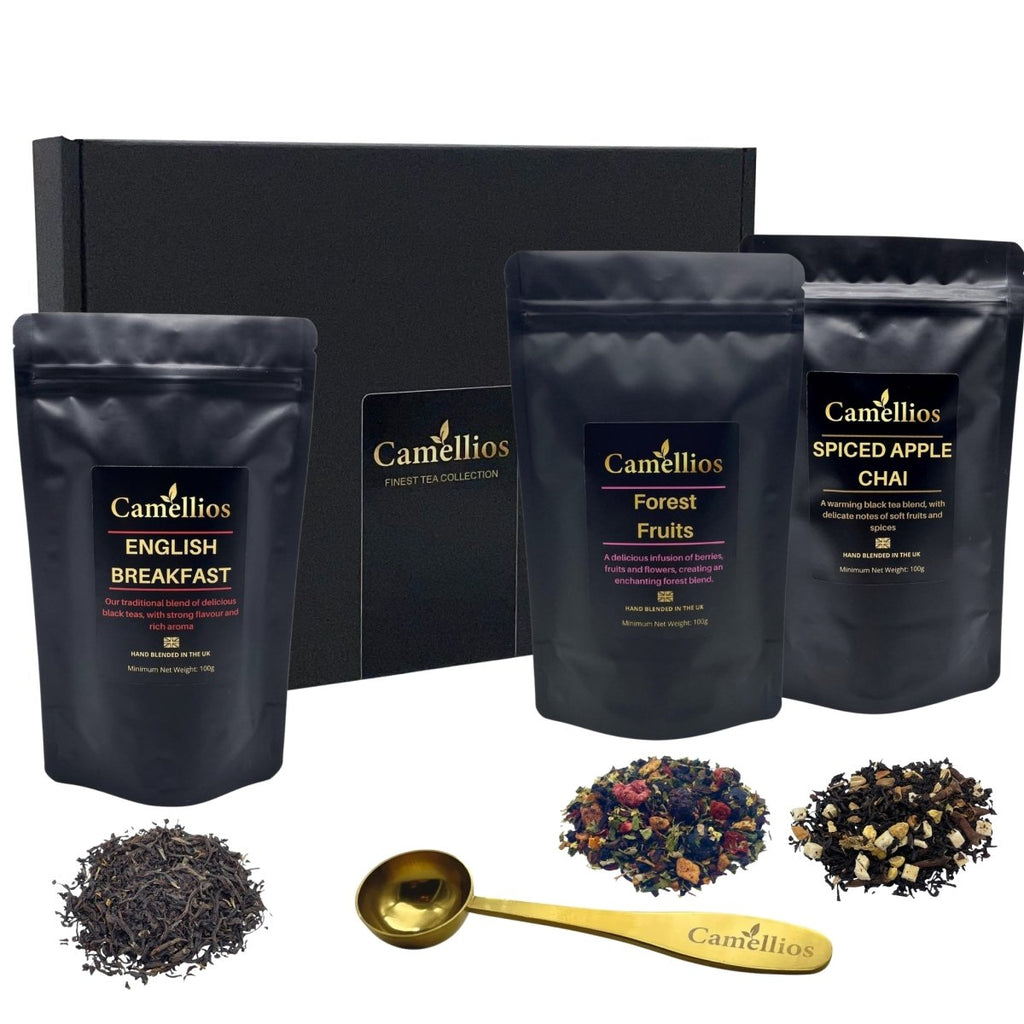 Luxury loose leaf tea gift box in black with three tea pouches and gold measuring spoon