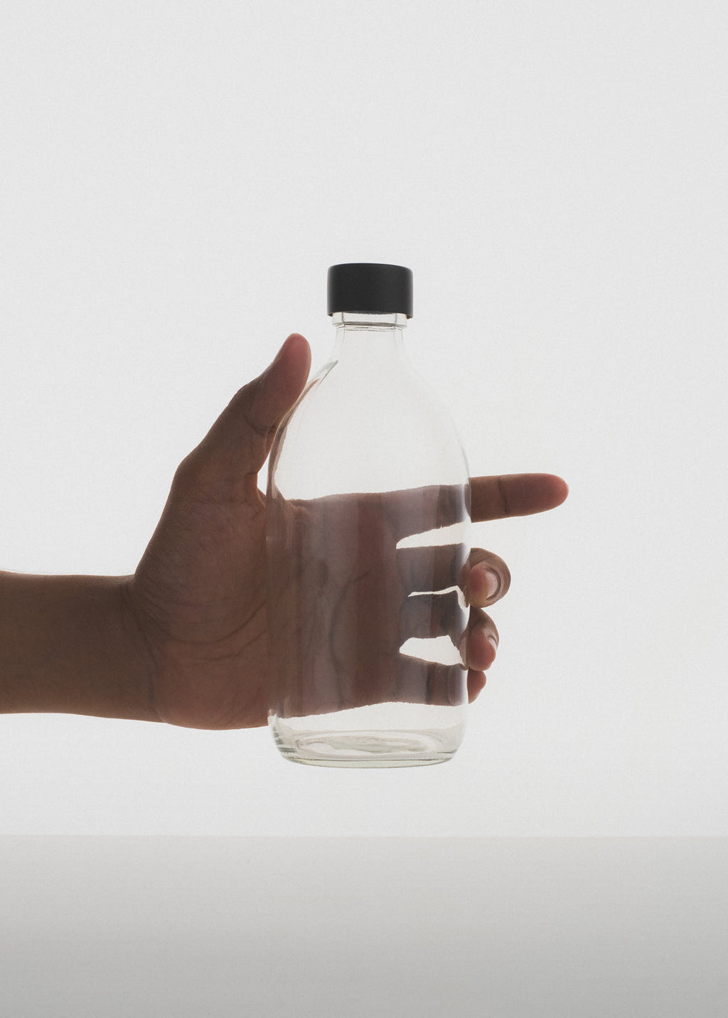 Clear glass storage bottle with a silver stainless steel screw cap for household organization — view 5